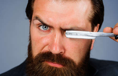 Handsome bearded man with straight razor. Barber shop, shaving. Advertising for barbershop....
