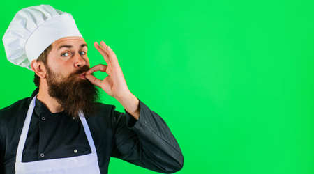 Professional chef showing delicious sign. Bearded cook or baker gesturing excellent. Perfect sign. Taste approval gesture. Copy space.の写真素材