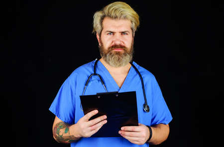 Doctor with clipboard. Male physician in medical uniform with documents. Healthcare and medicine concept.の写真素材