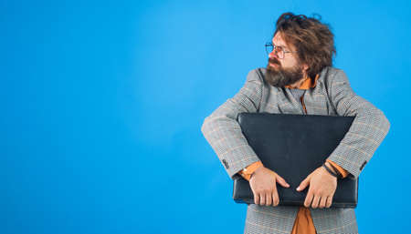 Confused businessman with suitcase. Bearded man in suit with briefcase. Office worker. Copy spase.の写真素材