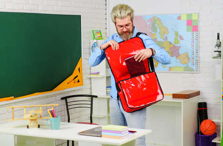 Bearded teacher or student with briefcase in classroom. Education. Studying. Learning. Back to...
