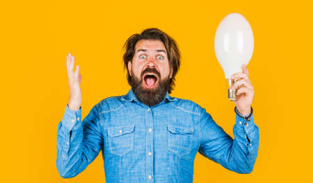 Good idea. Surprised man with big lamp. Bearded male with light bulb. Solution and decision.の写真素材