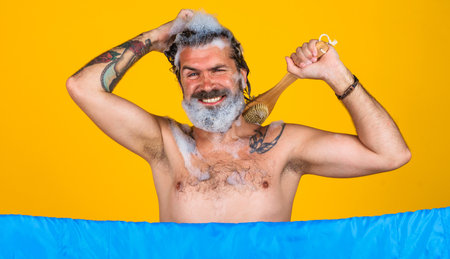 Handsome man take shower. Bearded male washing body with soap foam. Relaxing Time. Guy showering.