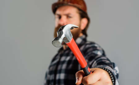 Mechanical worker, repairman or carpenter with hammer. Male builder in hard hat. Repairmentの写真素材