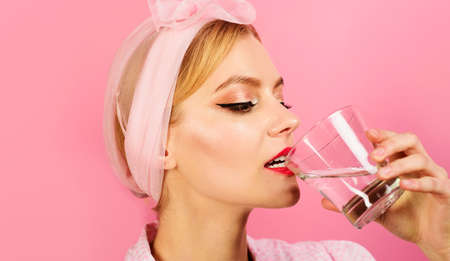 Woman drinking glass of pure water in the morning after waking up. weight loss. Healthy lifestyle, dietの写真素材