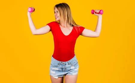 Exercise for arms. Sporty girl with dumbbells. Fitness woman working out. strength and motivationの写真素材