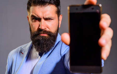 Bearded businessman with smartphone or mobile phone. Business, communication, internet, technologyの写真素材