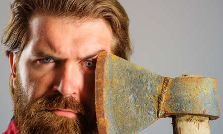 bearded man with axe. Canadian lumberjack with hatchet. logger tool. Male with ax. close-up portraitの写真素材