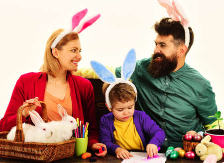 Easter holidays. family traditions. Mother, father and little son in bunny ears ready for holidayの写真素材