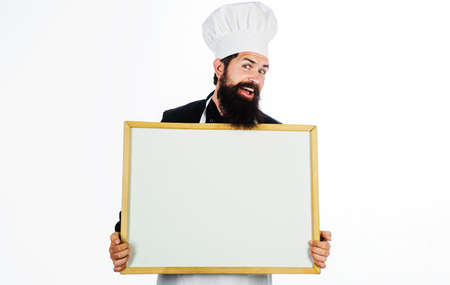 Restaurant chef with menu sign board. Male cook or baker with blank blackboard. Copy space for textの写真素材