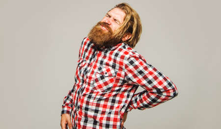 Handsome bearded man suffering from backache. muscle inflammation. lower back pain. Sport injuryの写真素材