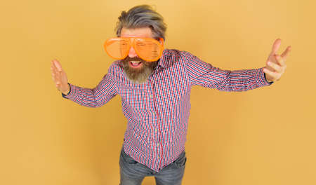 Happy bearded man in big funny sunglasses. advertising. sales and discount. season saleの写真素材