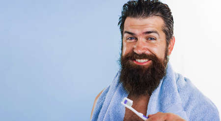 Bearded man with toothbrush cleaning teeth. dental care. oral hygiene. morning routine. copy spaceの写真素材