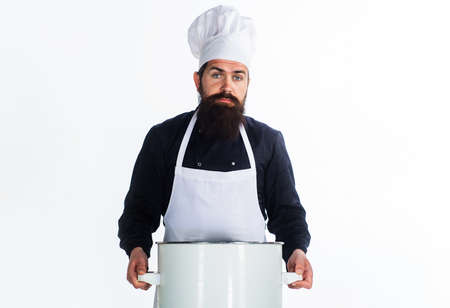 Male chef in cook uniform and apron with pot or saucepan. Cooking, culinary and food. kitchenwareの写真素材
