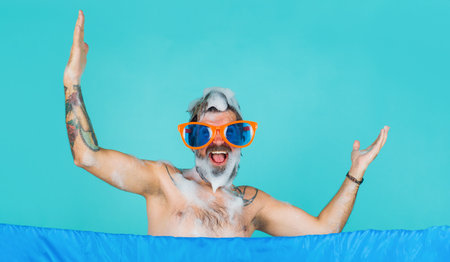 Happy man in funny glasses taking shower. Everyday hygiene. male bodycare. washing head. haircareの写真素材
