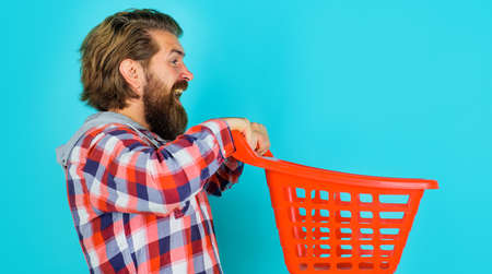 Happy bearded man with empty shopping cart. Buying spray. supermarket. sale. discount. black fridayの写真素材