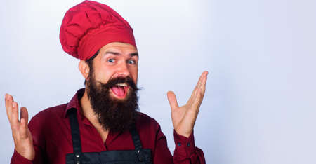 Smiling professional male chef in uniform and apron. Portrait of bearded cook or baker. Cookingの写真素材