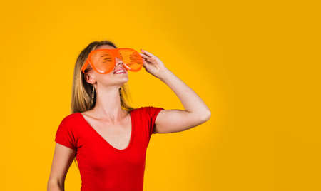Smiling girl in funny glasses looking at something. advertising. sales and discount. copy spaceの写真素材