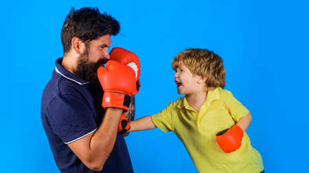 Boxing coach and kid training. Child in gloves learning boxing. father and son ready for sparringの写真素材