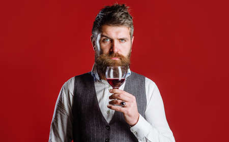 Man with wine glass. Bearded man with glass of wine. Tasting alcohol. red wine. Man drinks wine. Man with Bordeauxの写真素材