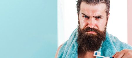Bearded man with toothbrush brushing teeth. Teeth cleaning. oral care. dental hygiene. Morningの写真素材