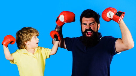 Little boxer champion and coach in boxing gloves. Ready for sparring. Child sportsman at training.の写真素材