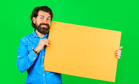 Smiling bearded man with empty board. advertising banner. season sales. online shopping. Marketingの写真素材