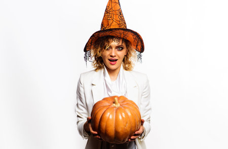 Woman in witch hat with pumpkin. Halloween party. October 31st. Jack-o-lanternの写真素材