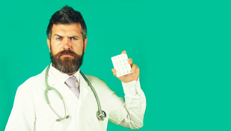 Doctor or pharmacist with pills. Physician in uniform with stethoscope. medicine and healthcareの写真素材