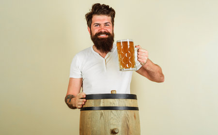 Man with mug of beer in pub or bar. Happy brewer with cup of ale. Pub and bar. Brewery conceptの写真素材