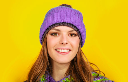 Smiling woman in warm knitted hat and scarf. fashion winter clothesの写真素材