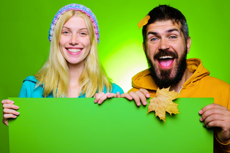 Happy couple with advertising board. Black friday sale banner. Autumn sales. Discountsの写真素材