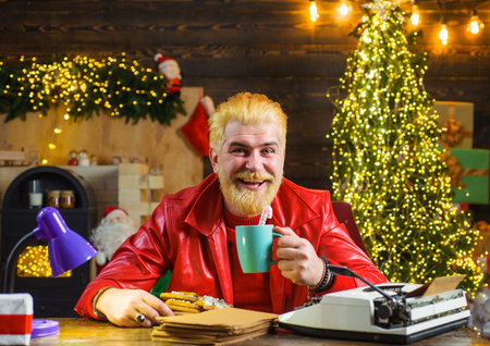 Smiling man in red leather jacket with mug of milk and cookies. Merry Christmas. New year backgroundの写真素材