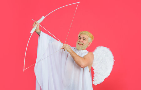 Valentines Day. Male angel with bow and arrows. Cupid in angelic wings shooting arrows of loveの写真素材