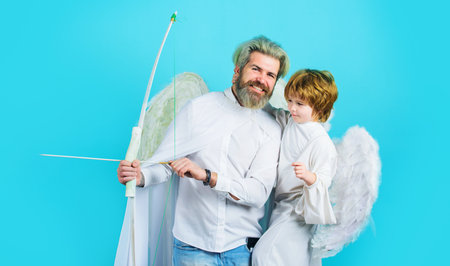 Valentines day. Little cupid boy and father with bow and arrow. Christmas angels. Cute angel
