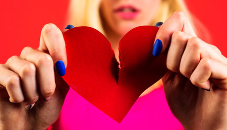Broken heart. Divorce. Breakup. Woman tearing paper heart. concept Break of relationships Closeupの写真素材