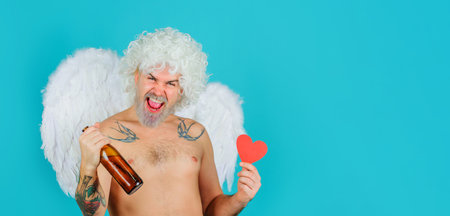 Valentines day. Naughty drunk cupid in angel wings with beer bottle and paper heart. Valentine cardの写真素材