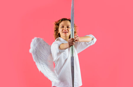 Arrow of love. Female angel with bow and arrows. Valentines Day concept. Cupid shooting love arrowの写真素材