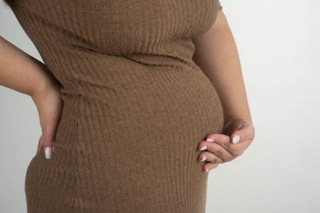 Pregnancy belly with caring hands. Pregnancy with gentle touch. Pregnancy maternity on white isolated. Pregnancy with natural belly abdomen. Pregnant concept.の写真素材