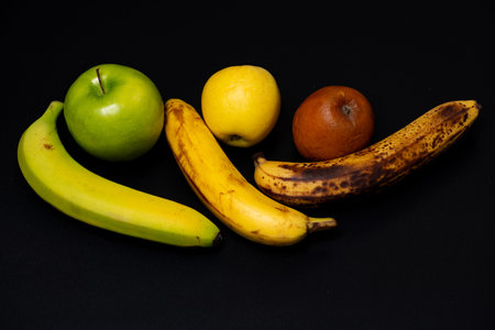 Banana young fruit before ripening. Banana natural fruit quality background. Banana overripe fruit after aging. Banana conceptual choices vs quality.の写真素材