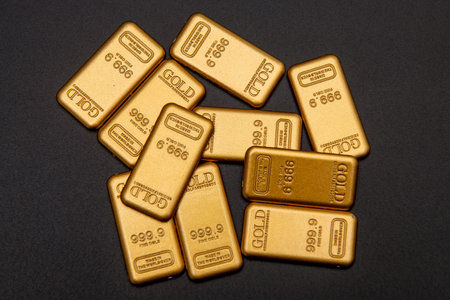 Fine gold in 24k on black. Fine gold bar. Gold for investment. Gold bars value.の写真素材