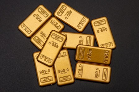 Fine gold in 24k on black. Fine gold bar. Gold for investment. Gold bars value.の写真素材
