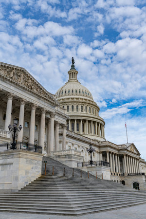 Capitol exterior historic landmark in Washington DC city. Capitol dome blue sky cloudy background....