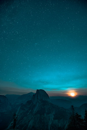Mountain landscape at night with starry sky and milky way