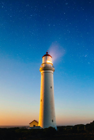 Lighthouse at night with starry sky and Milky Way. Long exposure.
