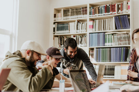 Group of young students studying together in the library. Education concept.