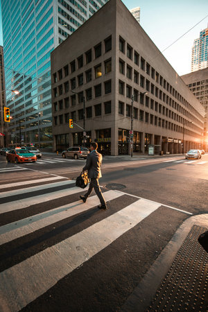 Businessman crossing the street in downtown Los Angeles, California, USA