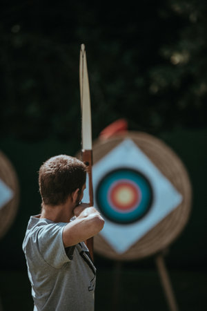 Archery archer aiming at the target with a bow and arrow