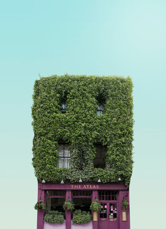 Vintage building with green ivy wall on blue sky background.の写真素材