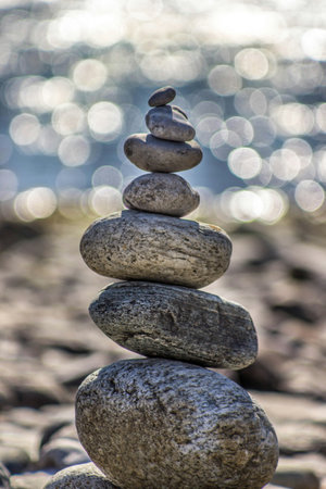 Stack of zen stones on the beach in the morning light.